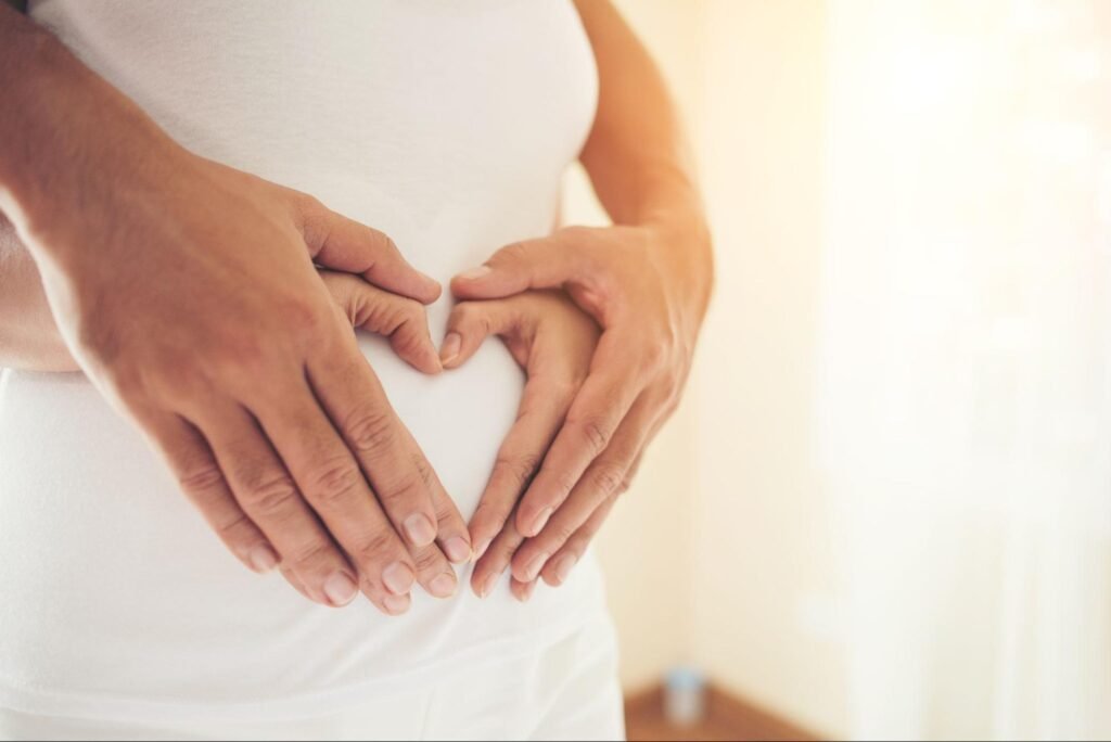 Woman holding positive pregnancy test after IVF