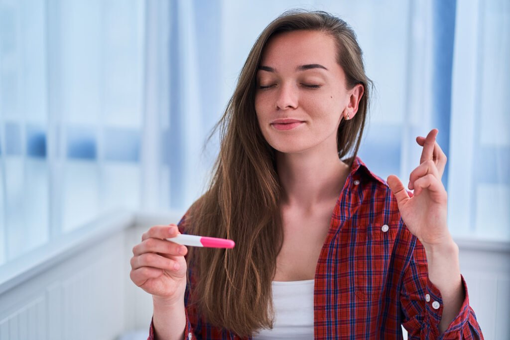 Woman using an ovulation test kit to track fertility